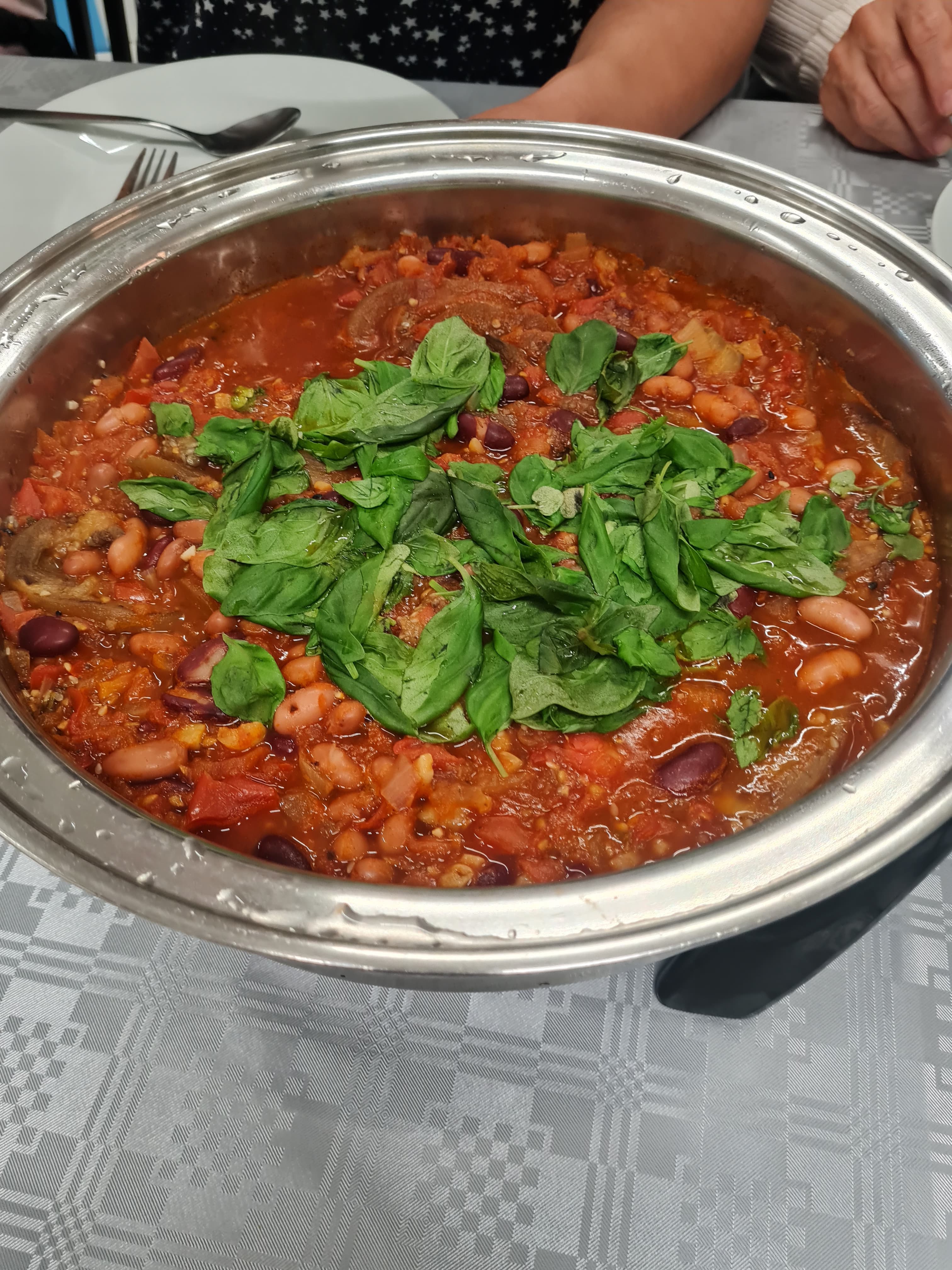 Khoresh bademjan topped with fresh basil in a Saladmaster pan