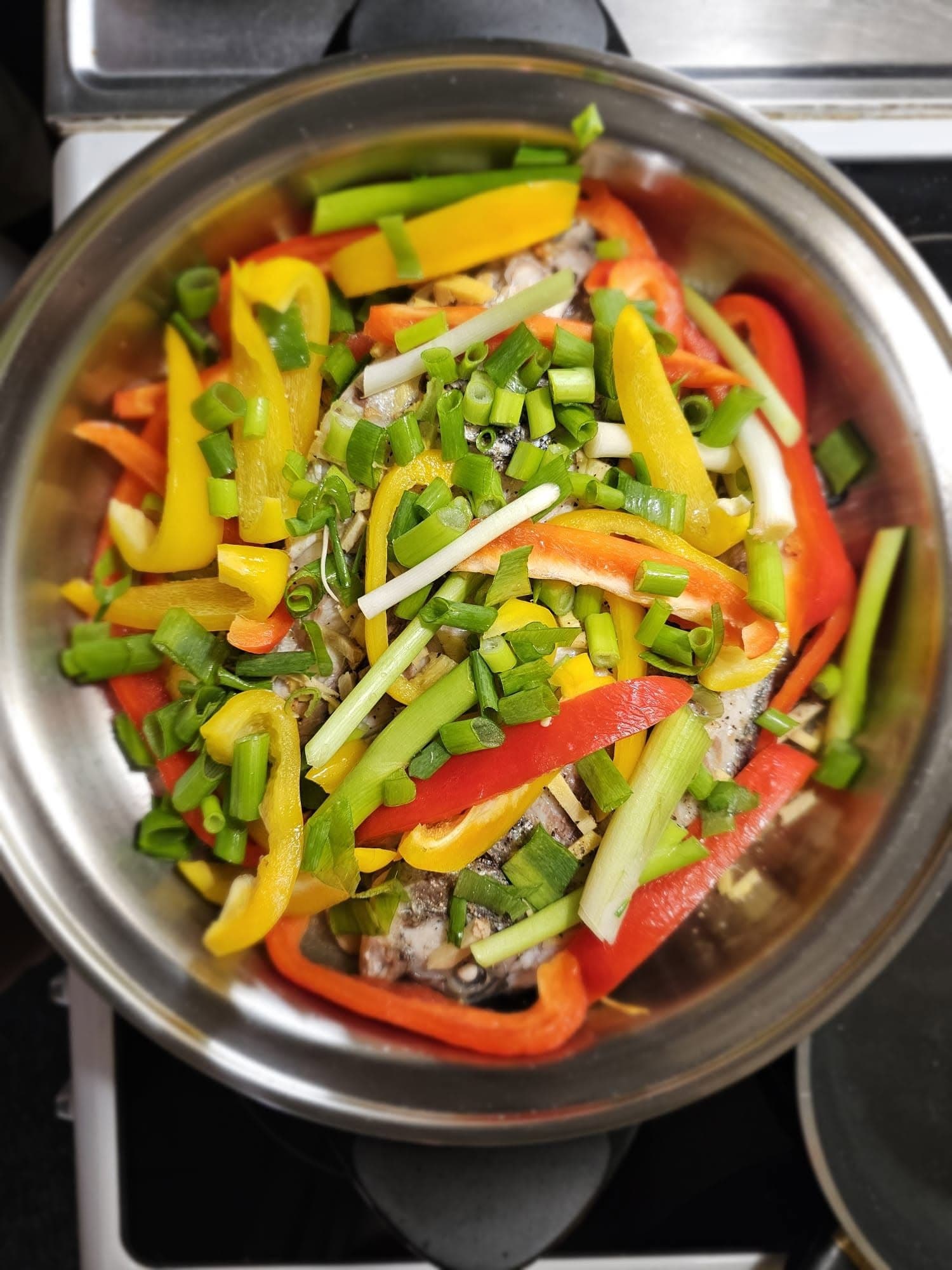Fresh fish baked with peppers and spring onions in a Saladmaster pan
